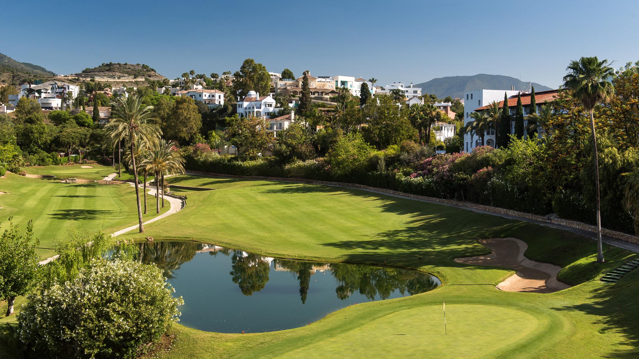 View of the course with a water hazard in front of the green and The Westin La Quinta behind