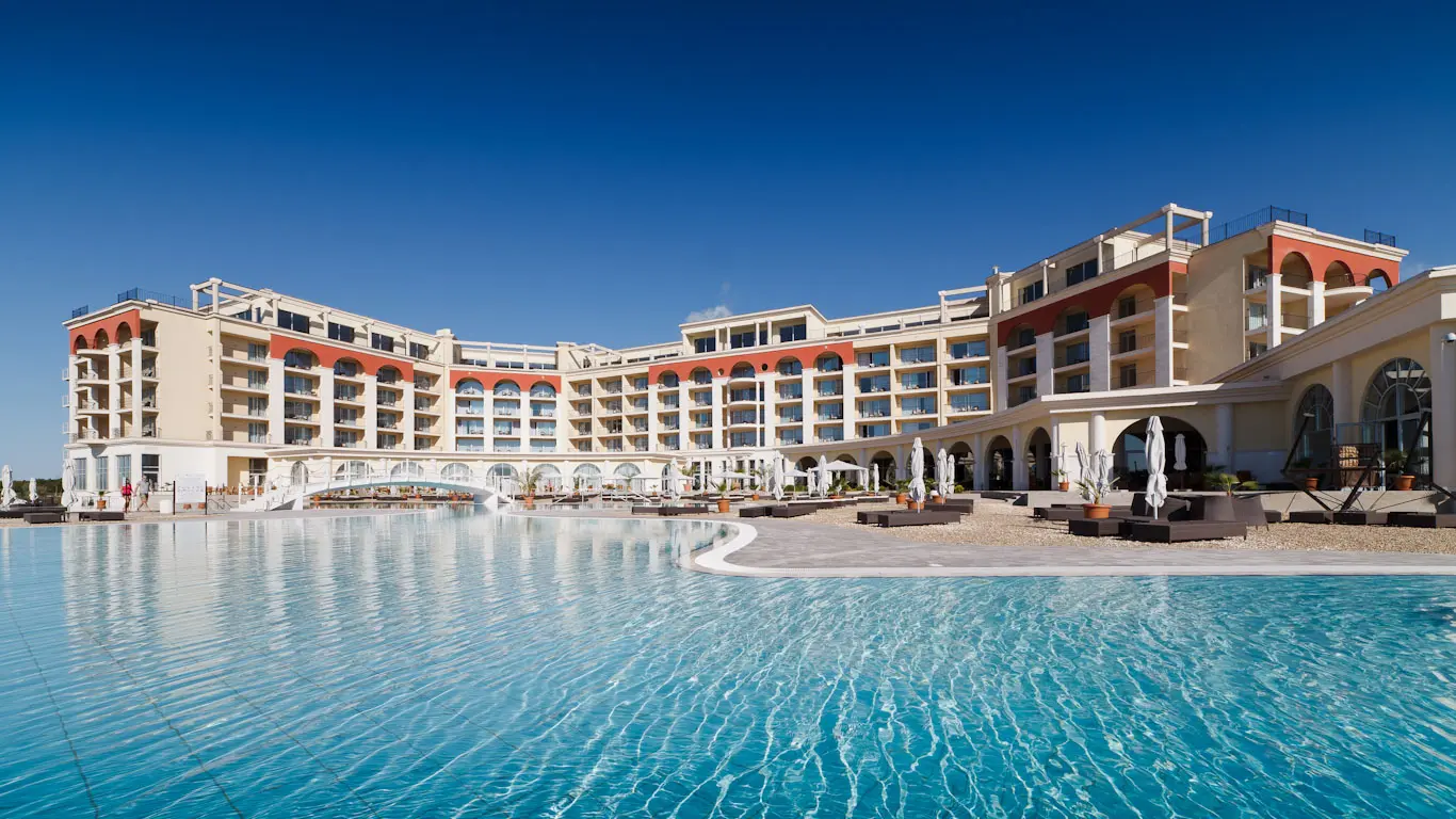 Panoramic view of the Lighthouse Golf & Spa Resort's swimming pool surrounded by sunbeds