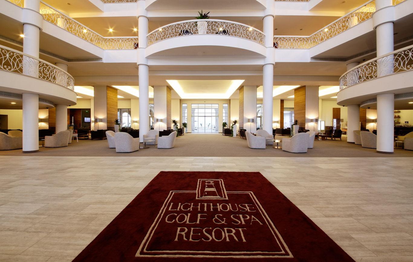 A branded carpet at the entrance of the resort with seating areas and a luxurious design