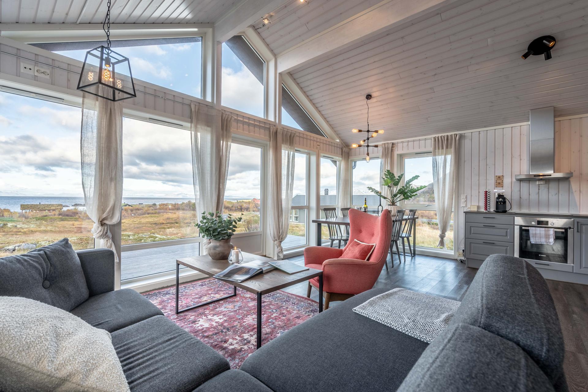 A living room at one of the Lofoten Links Lodges with a panoramic window