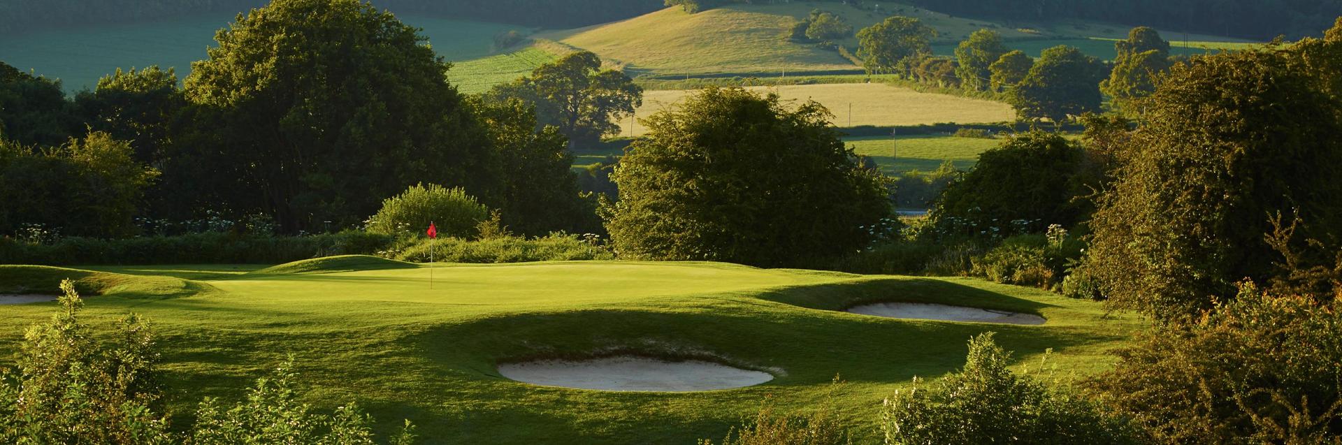 Lush greens with bunkers and a putting green