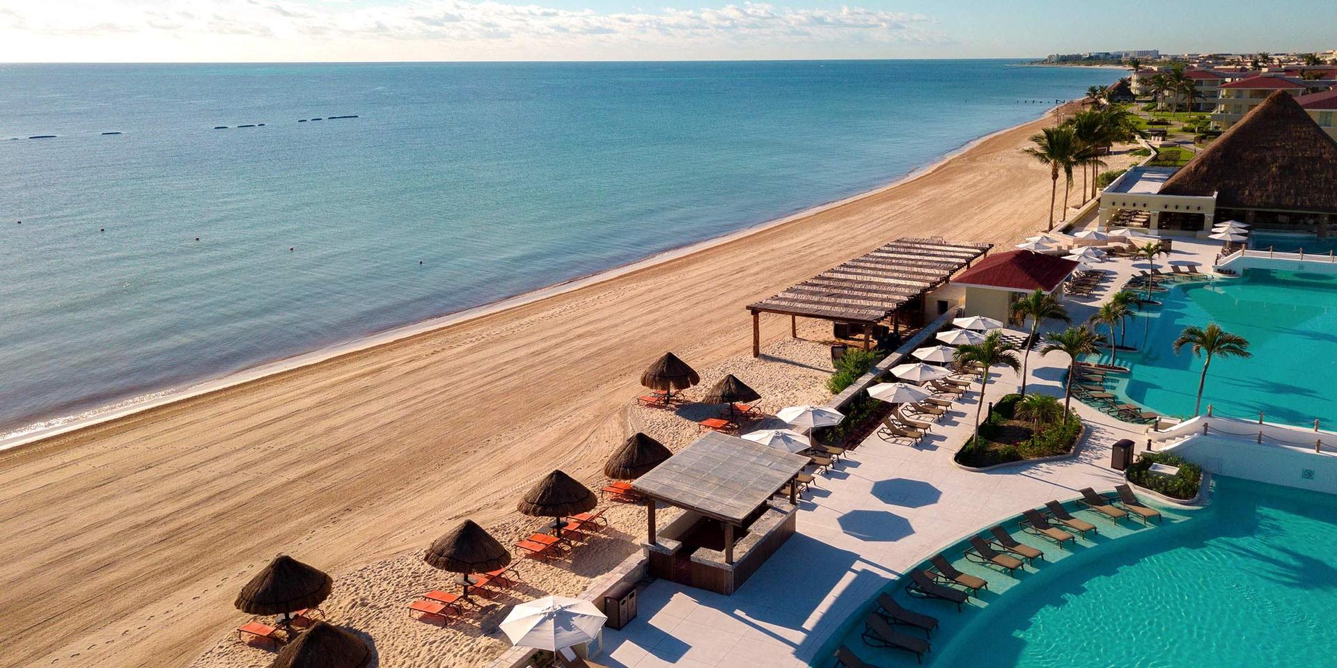 Overhead view of the resorts swimming pool leading to the beacch
