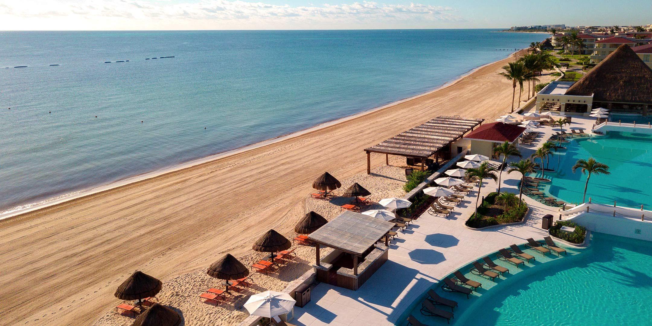Overhead view of the resorts swimming pool leading to the beacch