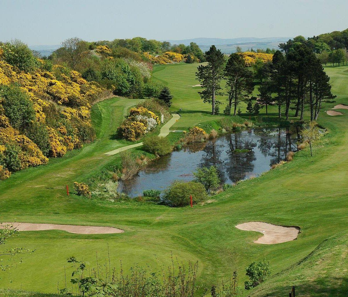 A pond reflects the surrounding trees and greenery in this picturesque section of the course.