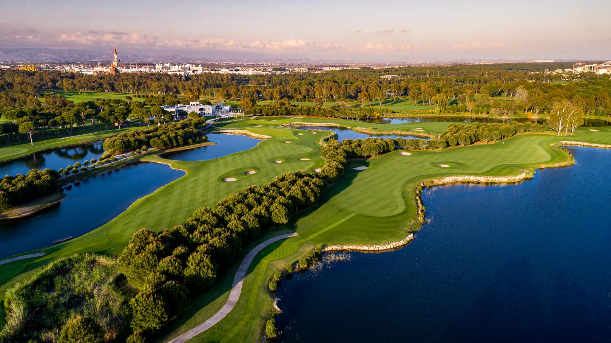 Winding fairways split by trees and flanked by water hazards