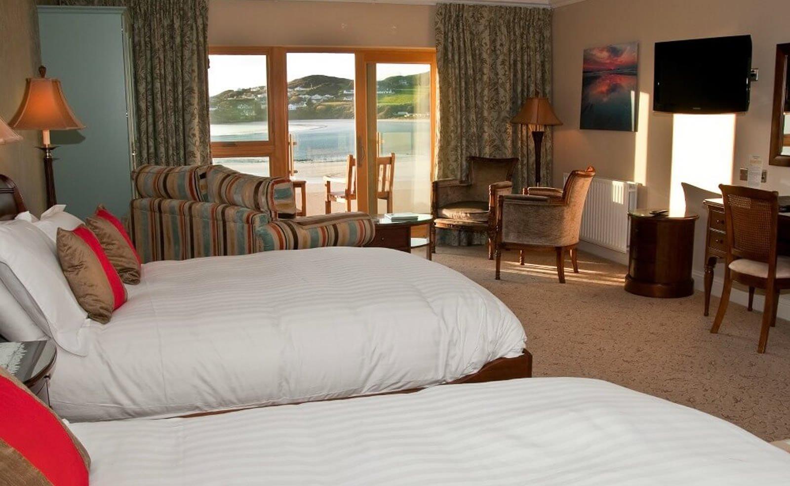 Double bed room at the Rosapenna Resort with a old fashioned look and a beautiful balcony overlooking the beach and sea