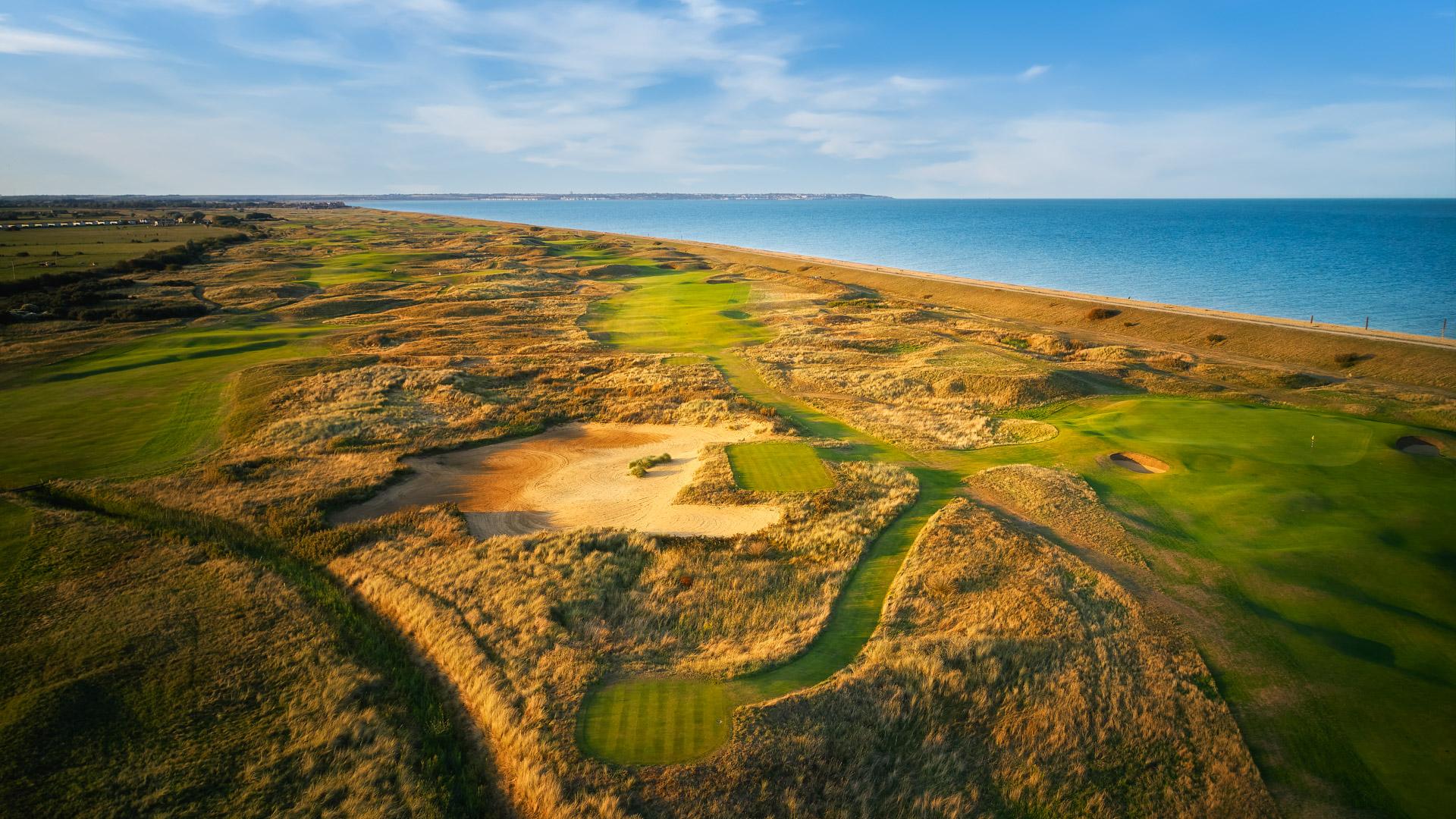 Golden dunes with rolling fairways by the ocean.