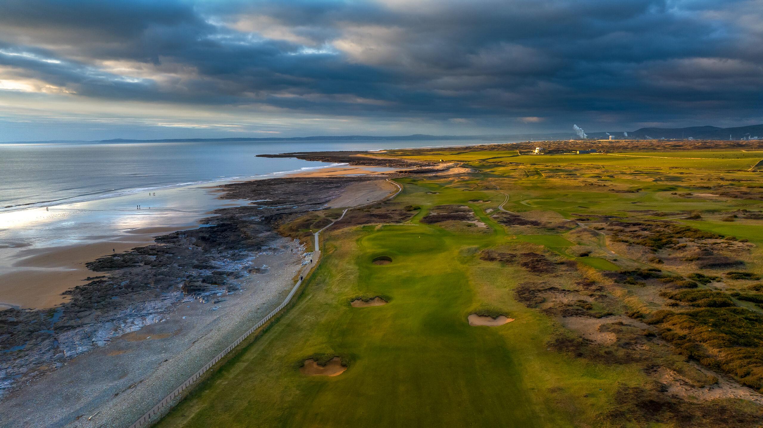 Aerial shot of the Royal Porthcawl Course with a rocky beach just moments away