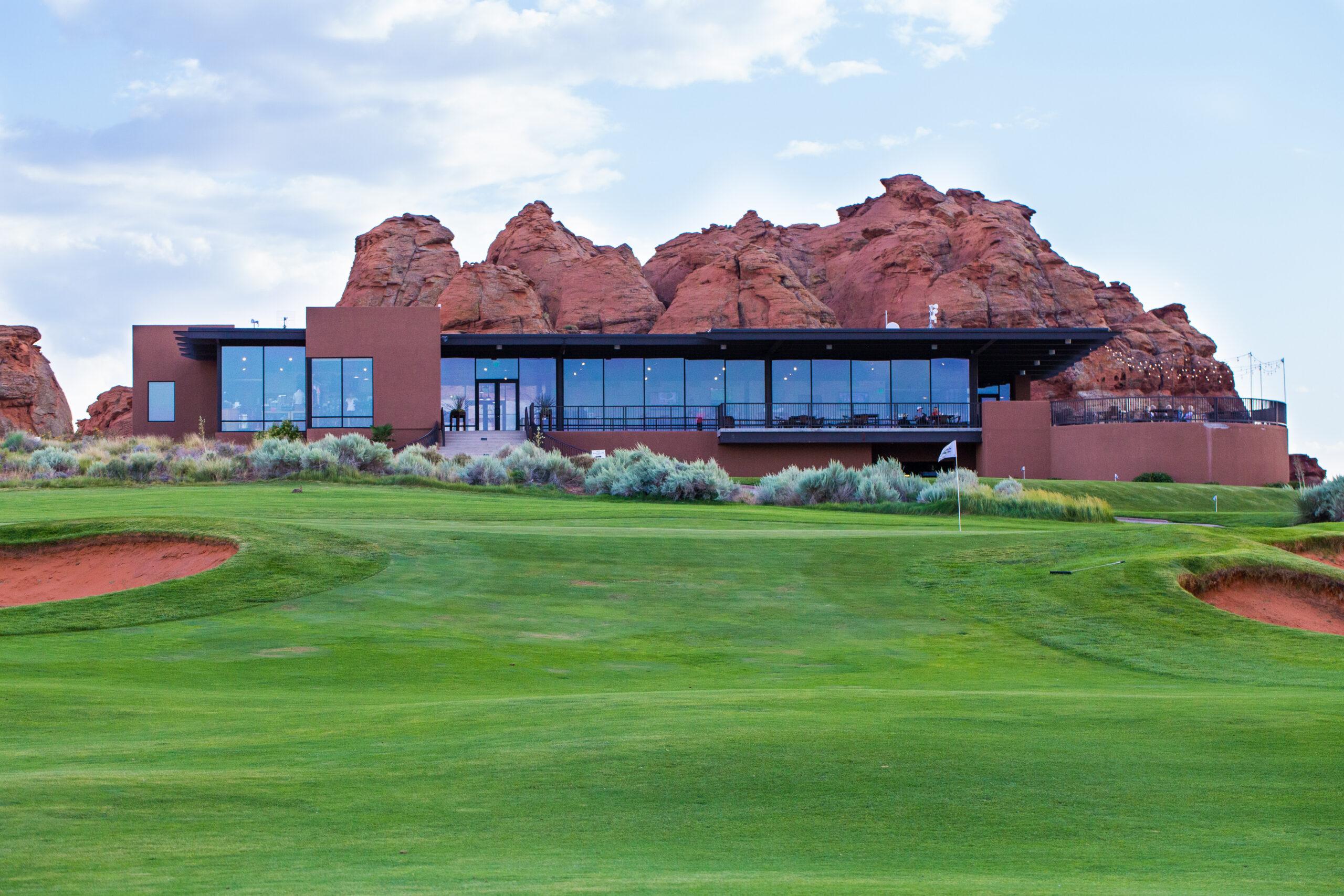 The Sand Hollow Resort clubhouse looking over a manicured green on the course