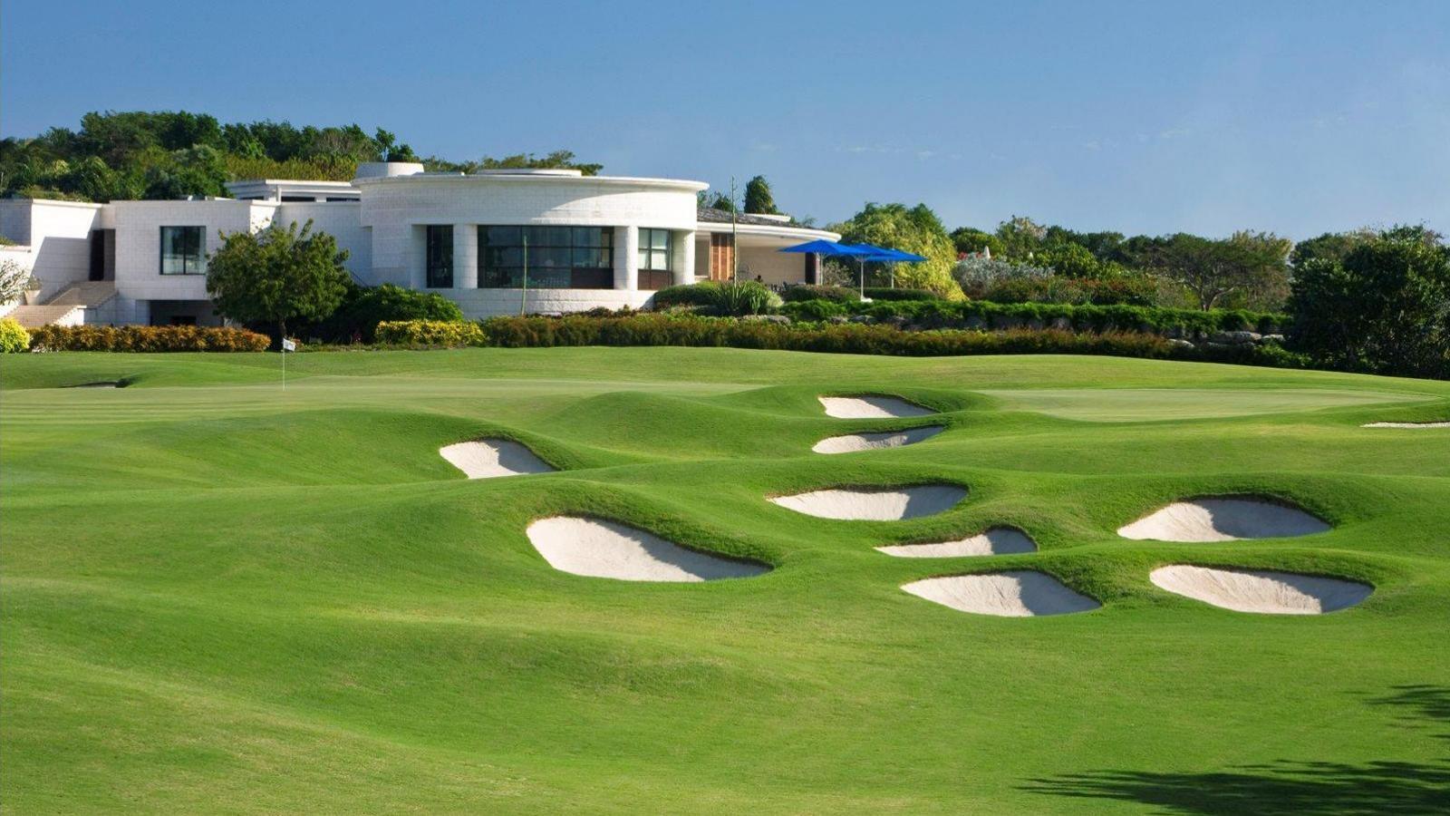 A striking view of the course with cliffside terrain and water hazards creating a visually dramatic and challenging layout.