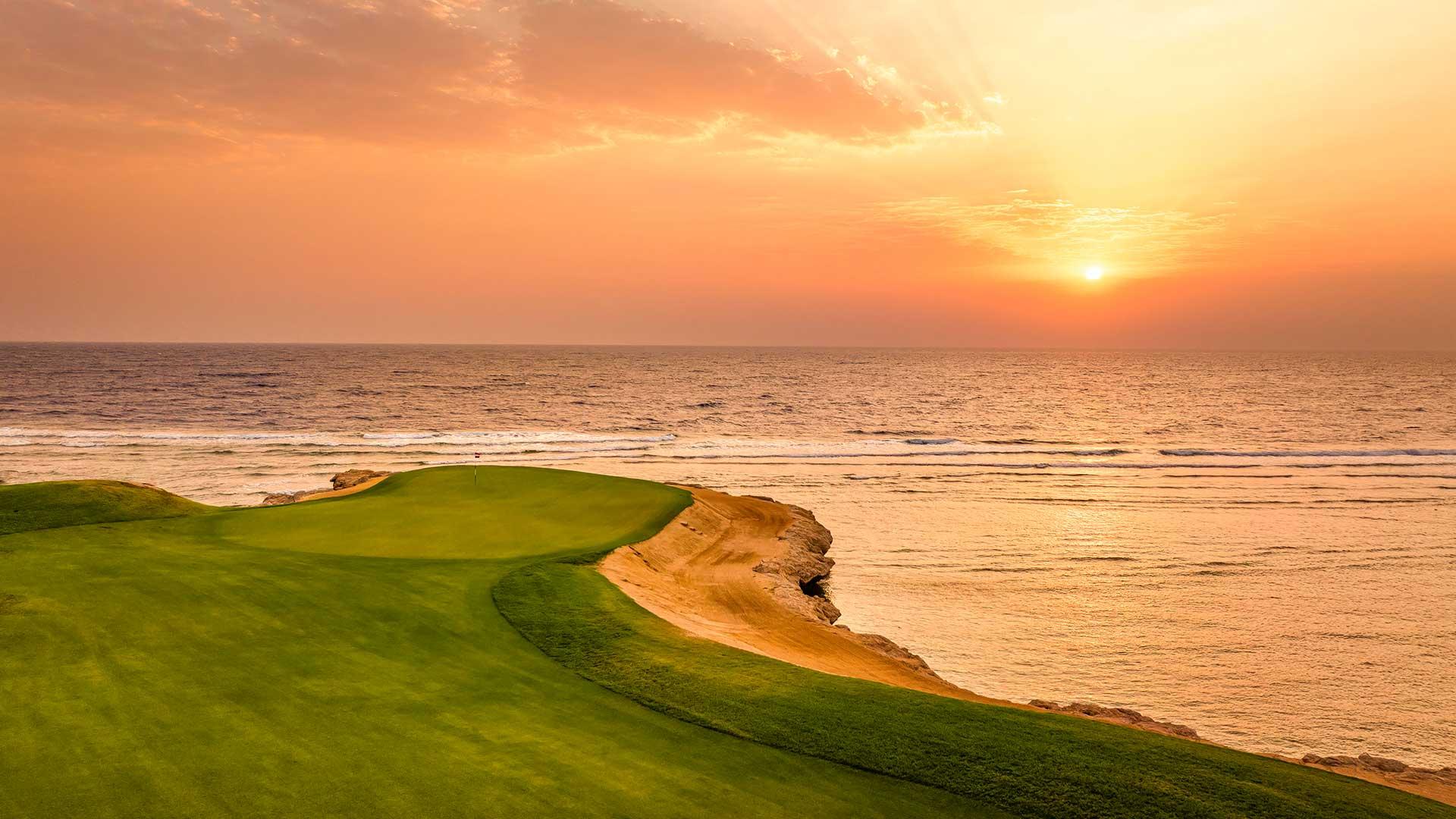 Sun setting over an island like green with coastal views