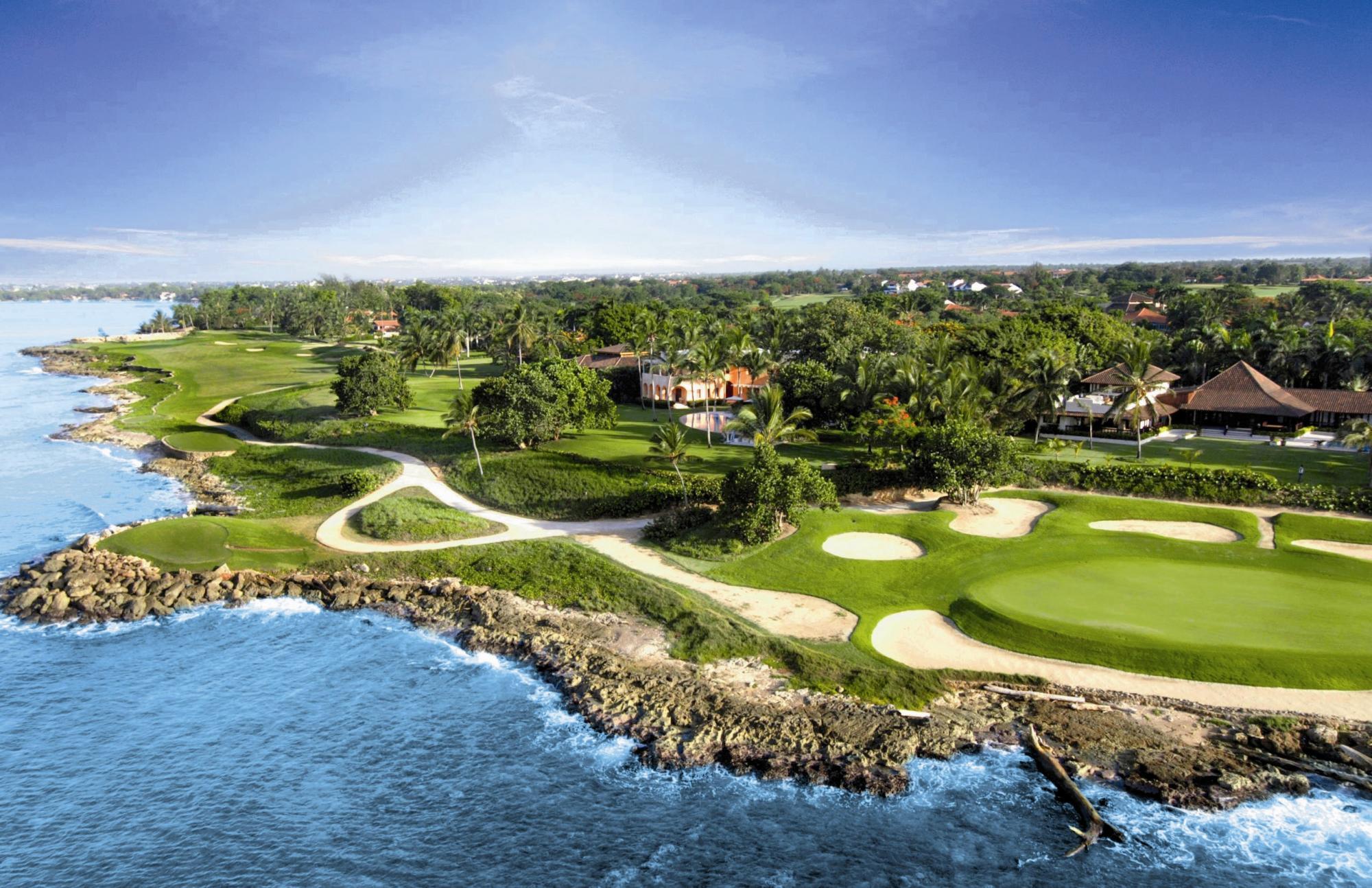 Overhead shot a well-maintained elevated green surrounded by sand bunkers