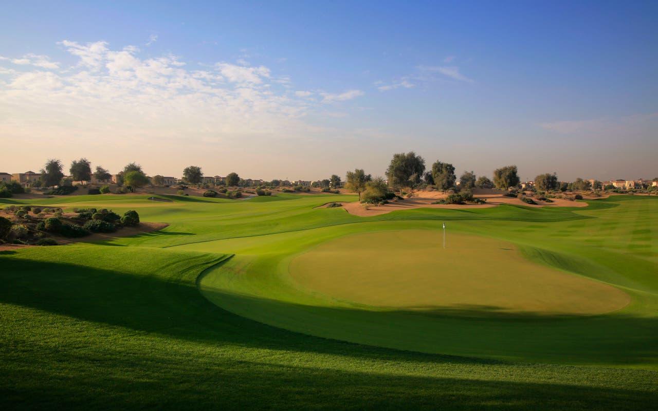 A well maintained fairway leading to a smooth green at The Els Club