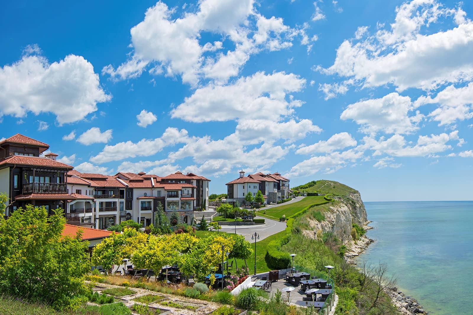 The cliff side resort buildings over looking part of the course with sea views