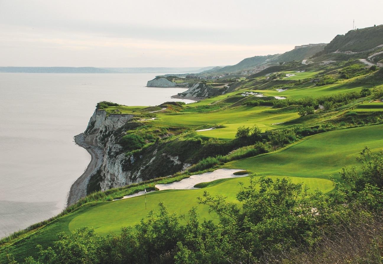 Overhead view of the Thracian Cliffs Golf & Beach Resort littered with rolling dunes running along the coast