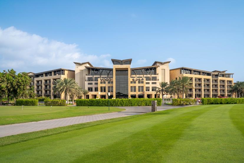 The VOGO Abu Dhabi Golf Resort & Spa building under blue skies