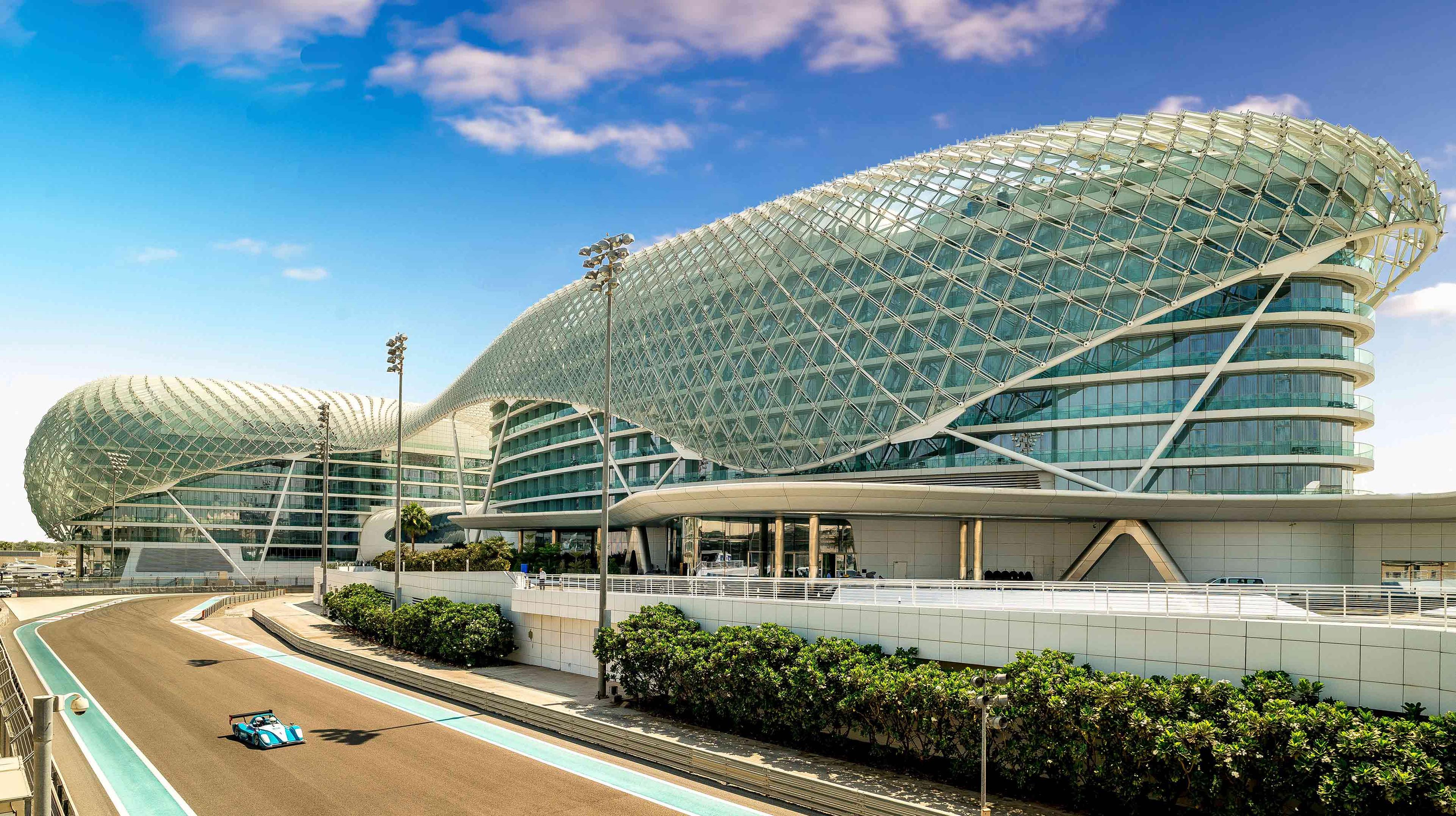 Exterior view of the W Abu Dhabi Yas Island hotel building overlooking a race track