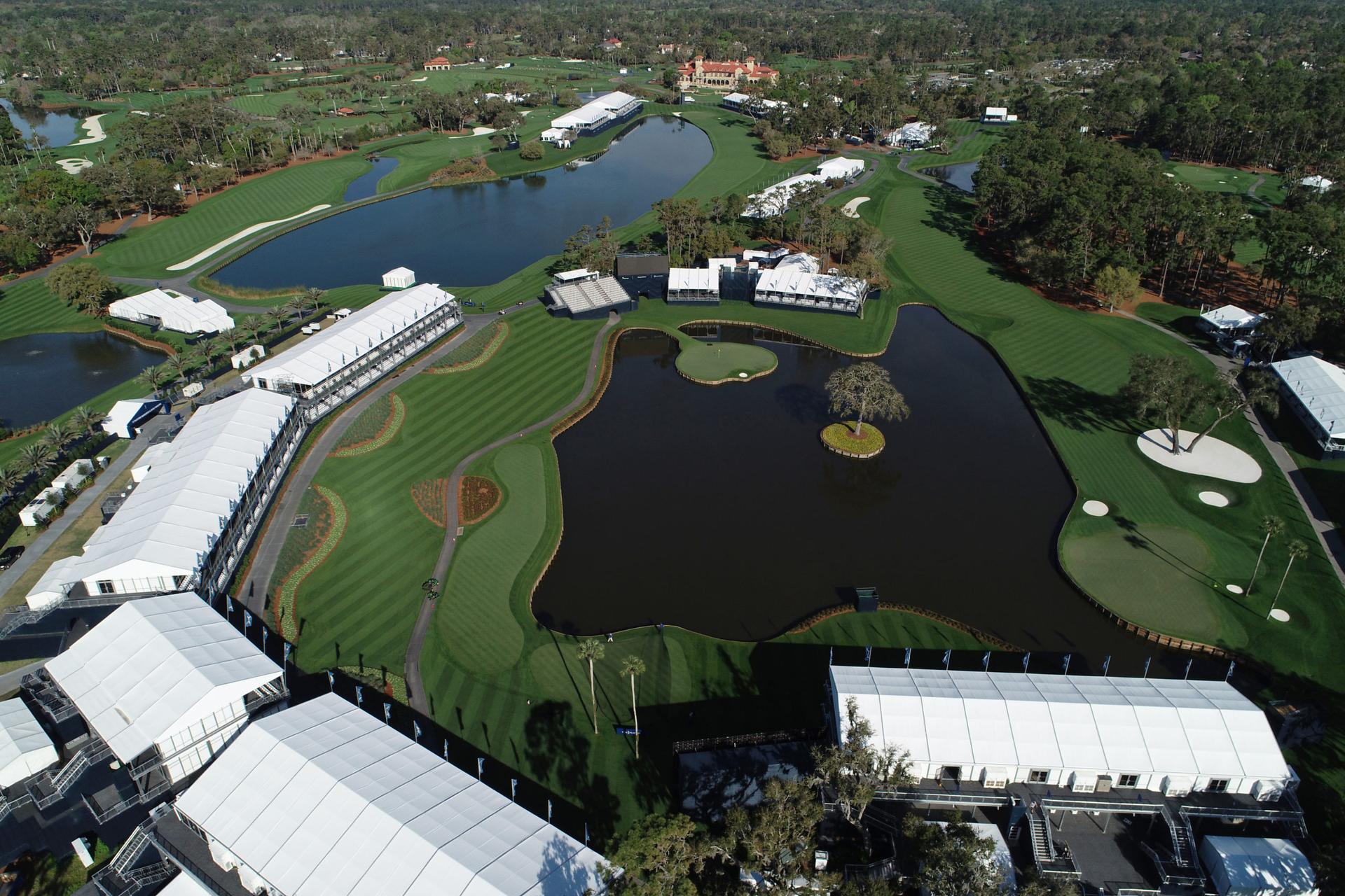 Overhead view of the course surrounding by spectator booths with a large water hazard in the centre
