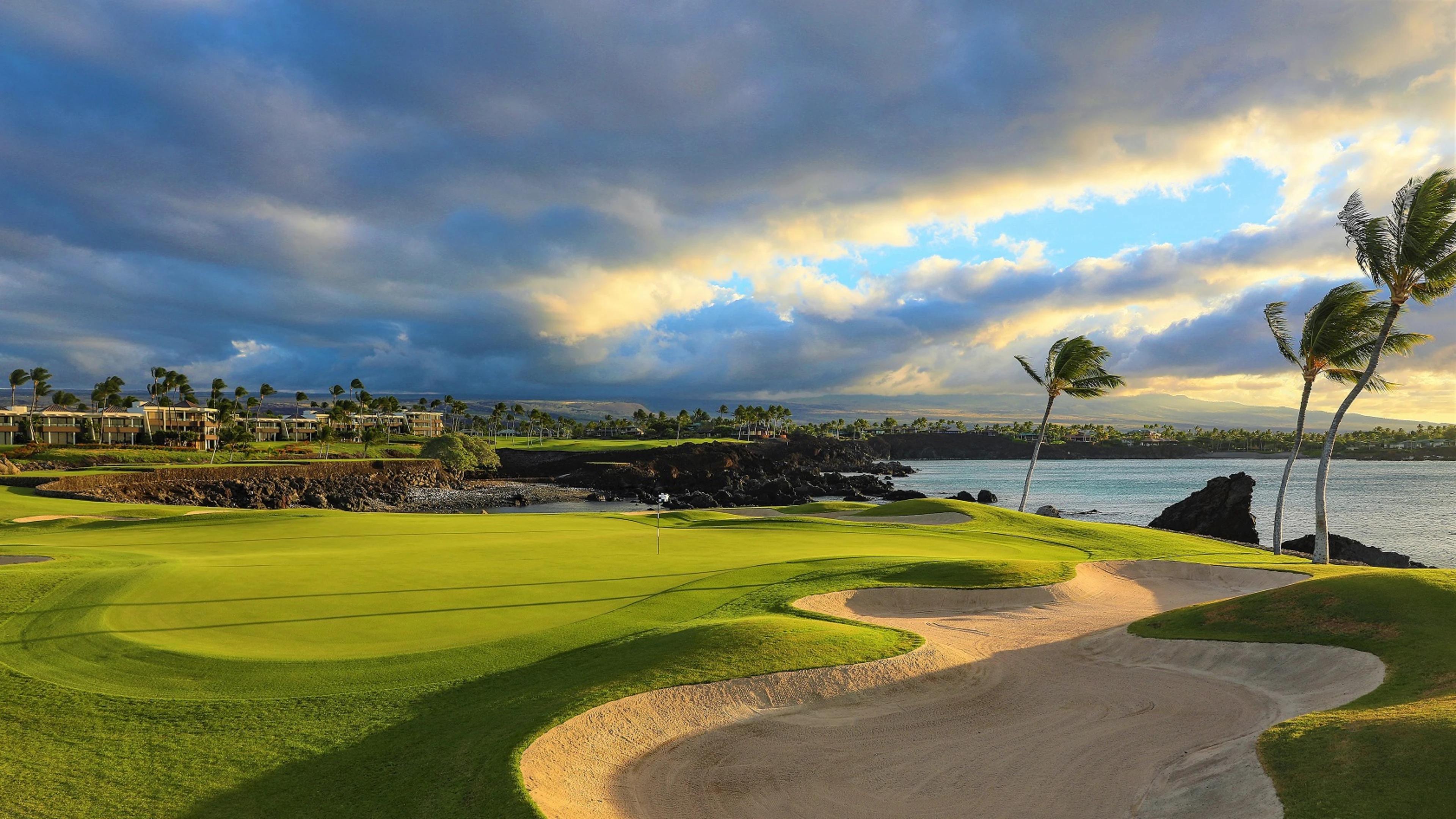 Panoramic view of a smooth green next to a sand bunker