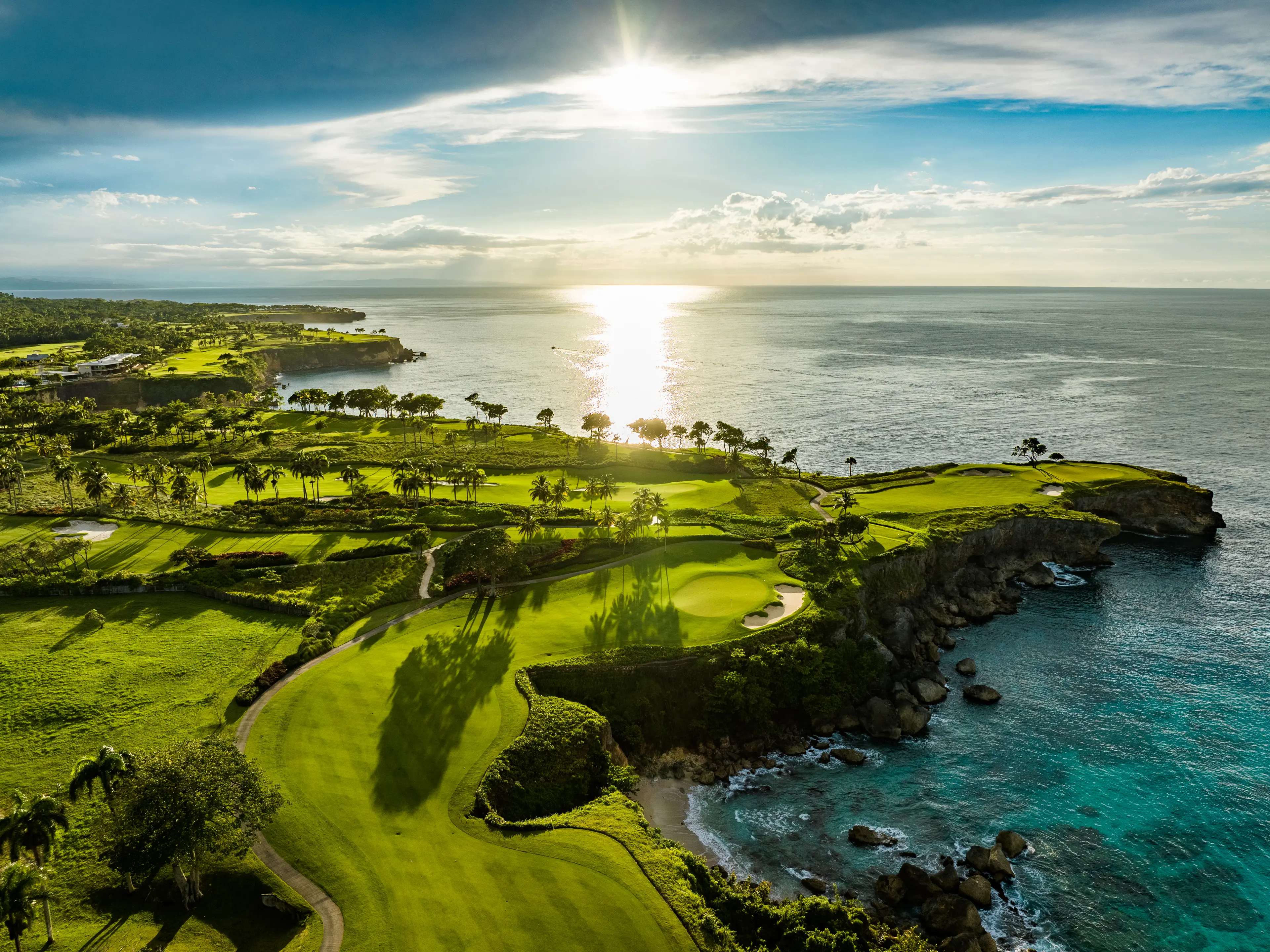 Aerial view of a coastal golf course at sunset